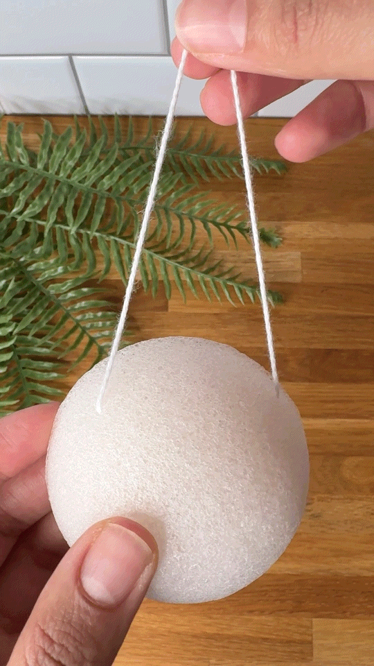 Woman using a konjac facial sponge wo wash her face